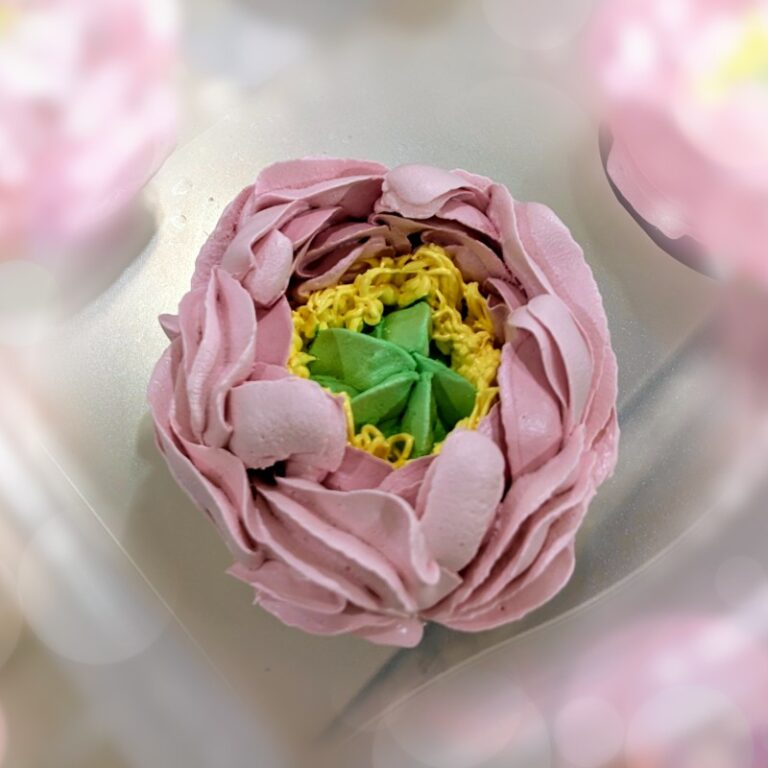 Close-up of a pink and green handmade marshmallow flower